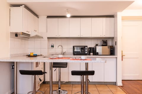 Departamento Suites | Private kitchen | Mini-fridge, microwave, oven, stovetop