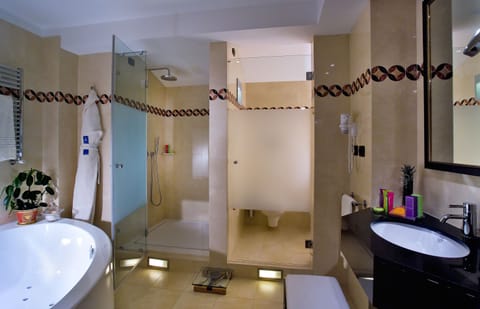 The Level Ambassador Suite | Bathroom | Combined shower/tub, deep soaking tub, designer toiletries, hair dryer