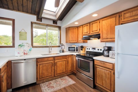 Fully equipped kitchen with appliances, dinnerware, silverware, cookware.