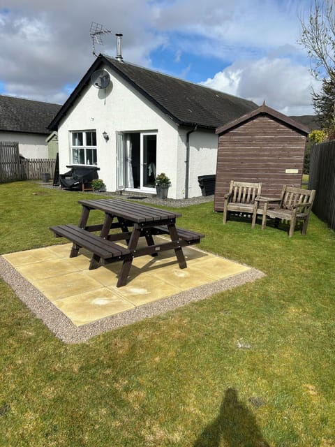 The back of the cottage with the new picnic patio and new composite decking.