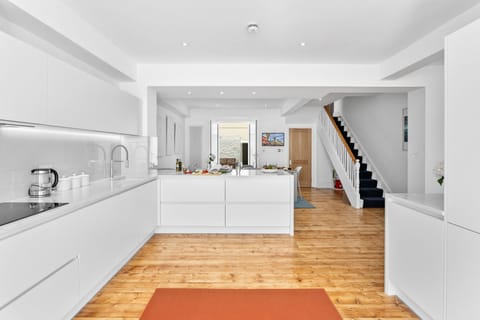 Open-plan kitchen and dining leading to a private, furnished patio.