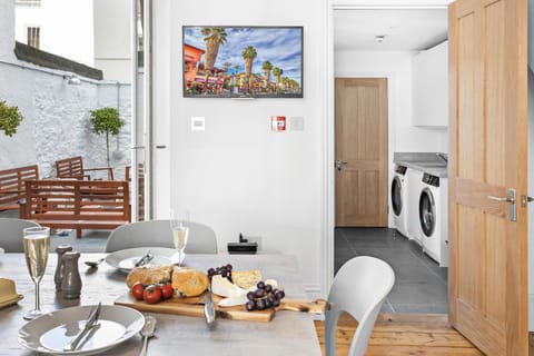 Kitchen leads to the utility room with AEG washer, dryer, iron, steamer, etc.