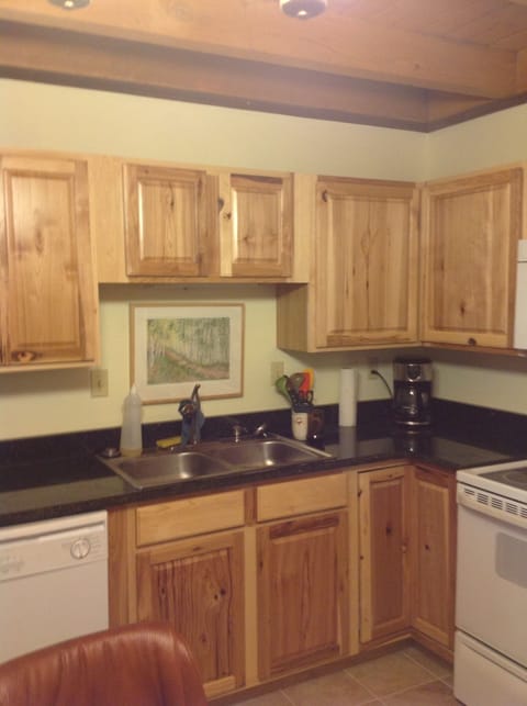 Renovated kitchen with new cabinets and granite counter tops.