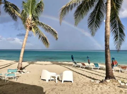 On the beach, white sand, sun loungers, beach umbrellas