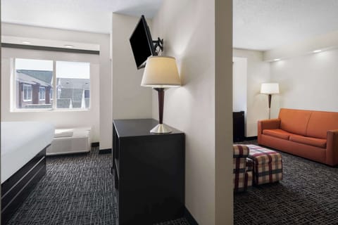 Suite, 1 King Bed, Non Smoking | Desk, laptop workspace, blackout drapes, iron/ironing board