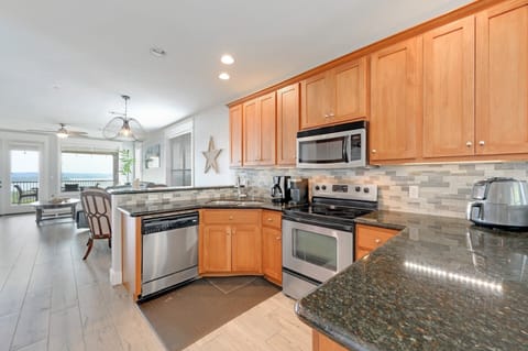 Kitchen with view toward dining/living/balcony