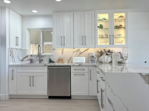 In cabinet lighting and spacious peninsula with bar seating.