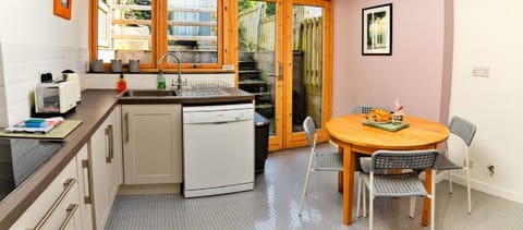 Dining area & kitchen. Spacious & airy, mod cons & doors to the terrace