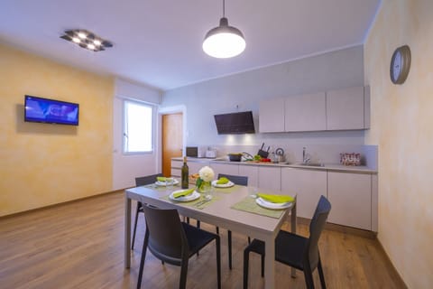 The living room with dining table and TV