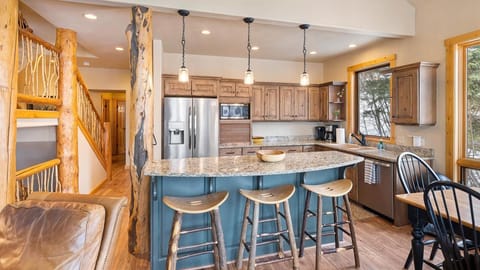 Open concept living room, dining area, fully stocked kitchen, and outdoor dining space.