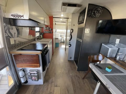 Airstream kitchen includes 3 burner stove, small oven, small microwave, and sink. The Airstream fridge should only be used for dry storage.