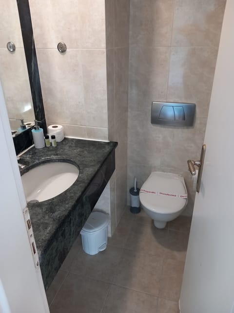 Bathtub, towels, shampoo, toilet paper