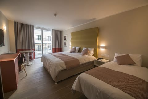 Triple Room, City View | Premium bedding, minibar, in-room safe, desk