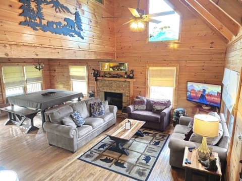 Enter into the warm, cozy living room with vaulted ceilings, where you can hang out, watch TV, or read your favorite book while you're all curled up next to the fireplace.