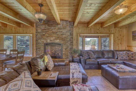 Upon entry you have a lovely, wood lined, open living/dining space with tons of seating for all 10 guests, as well as a gas fireplace to enjoy.