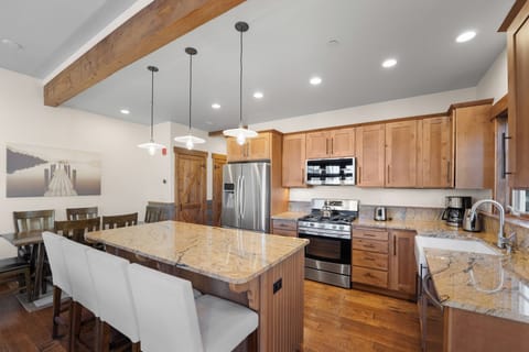 Modern full size kitchen offering granite countertops, beautiful cabinetry, and stainless steel appliances throughout.