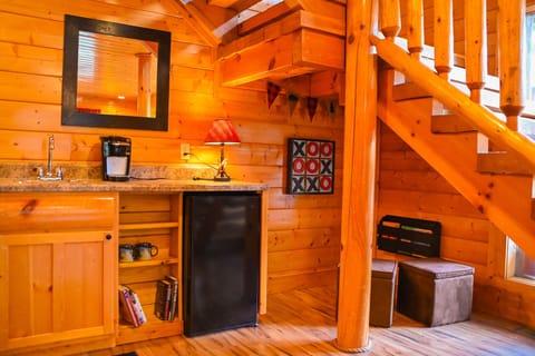 Includes a sink, mini fridge, and book nook under the stairs for the kids.
