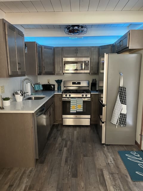 Kitchen area fully stocked with dishes etc