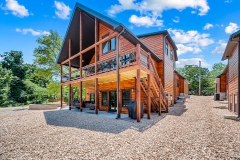 Back view. Firepit, private hot tub, propane grill, and swings will make this your dream vacation spot