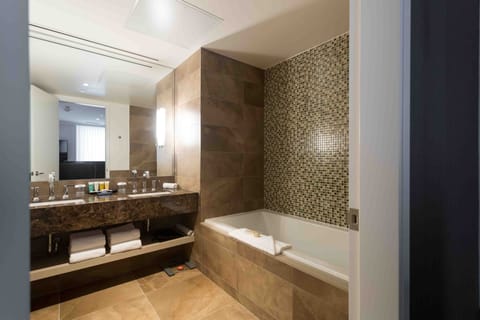 Deluxe Room, 1 King Bed | Bathroom | Designer toiletries, hair dryer, bathrobes, slippers