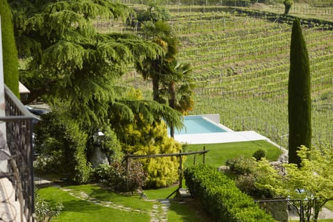 Outdoor pool, an infinity pool, pool umbrellas, sun loungers