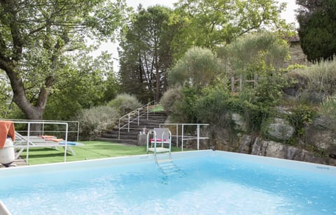 The pool is out of ground, but built into the side of the hills and a decent size