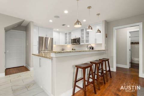 Large kitchen with bar seating and dining area