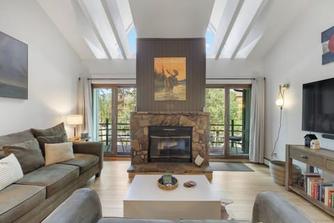 Living room with electric fireplace, 65" TV, private deck