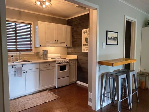 Kitchen boasts oven, full fridge, microwave and coffee makers.