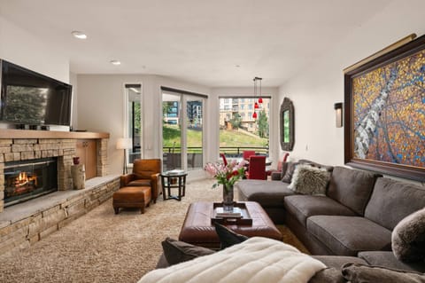 The living area offers a large but cozy sectional sofa, gas fireplace, and a flat screen TV. It is a great room for gathering!
