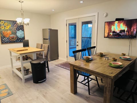 Second dining and living area with doors opening onto covered patio