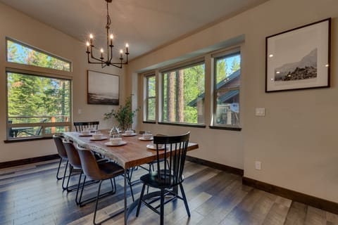 - Dining room with rustic wood table
- Seating for group gatherings cabin
- Surrounded by large bright windows