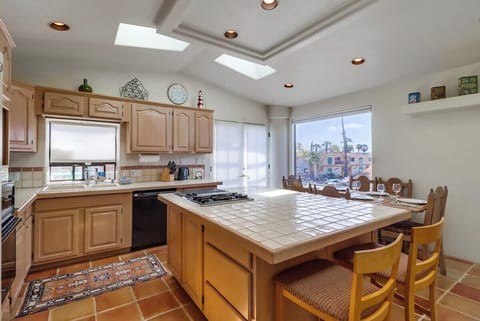 Fully equipped kitchen for meals at home! Plenty of space to prep for a meal on the balcony grill and enjoy at the inside or outside dining tables
