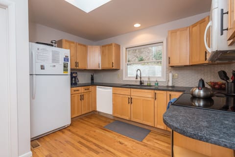 The kitchen features modern stainless steel appliances, generous counter space, and an open layout ideal for preparing meals and entertaining.