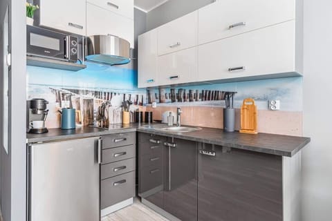 A compact and modern kitchenette with all essential appliances, offering an efficient workspace.