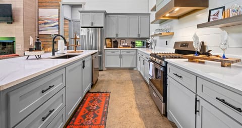 Cook up memories in a kitchen where sleek appliances and a dash of country decor blend seamlessly