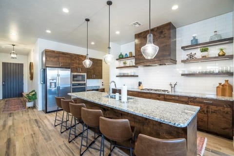 Large kitchen with island bar seating for 6 people