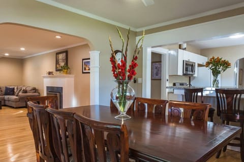 Share meals and conversations at this spacious dining table, perfectly positioned between the kitchen and cozy living room.