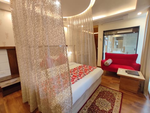 Luxury Room, 1 King Bed | Living area | 42-inch flat-screen TV with satellite channels, TV, heated floors