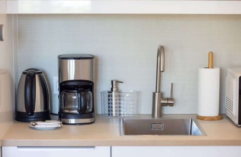 The kitchen counter is equipped with a coffee machine and an electric kettle for preparing your favourite drinks. 