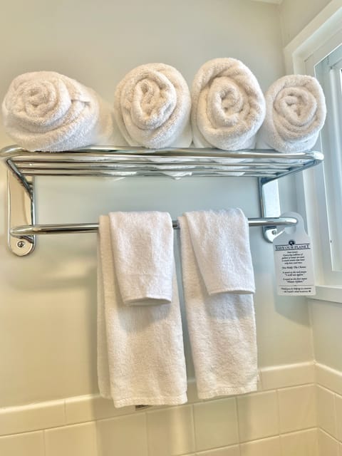 Shower, designer toiletries, hair dryer, towels