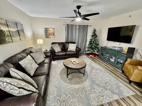 Family room with queen sleeper sofa and love seat and 55" smart TV