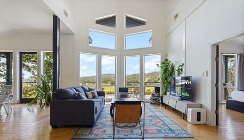 Living room with gorgeous windows, smart tv, and sleeper sofa