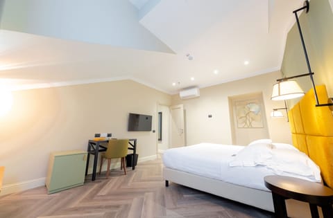 Executive Triple Room | Minibar, in-room safe, desk, soundproofing