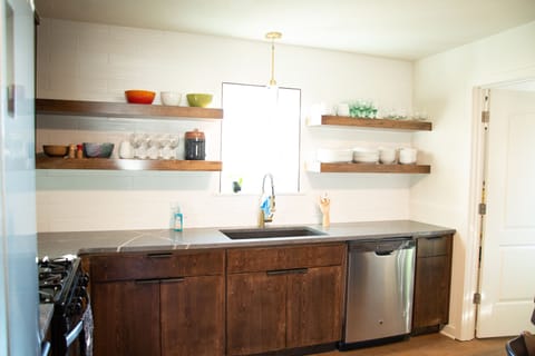 Kitchen includes coffee maker, kettle, toaster, microwave and more