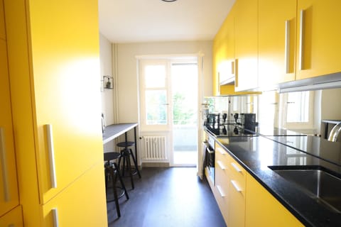 Kitchen has access to mini balcony facing the street.