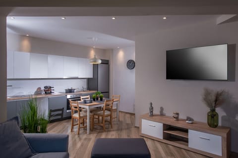 View of kitchen and TV in living room