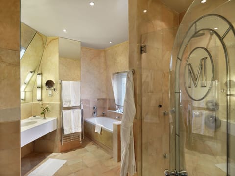 Combined shower/tub, designer toiletries, hair dryer, slippers