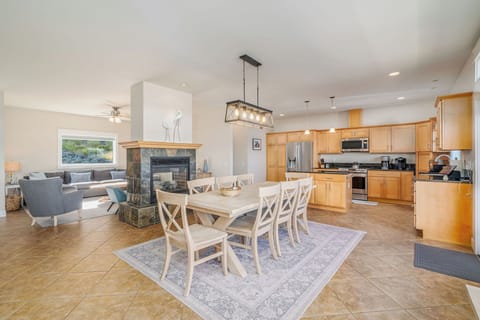 Open concept living, dining and kitchen with fireplace.