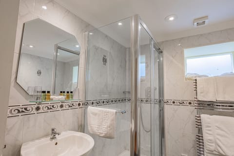 Junior Suite with Outdoor Seating | Bathroom | Combined shower/tub, hair dryer, towels
